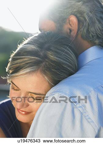 Stock Image - Mature man embracing mature woman. Fotosearch