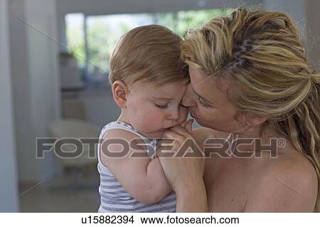 Picture - Mother consoles baby. Fotosearch