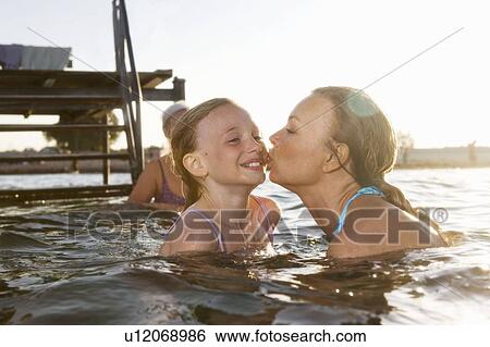 Mother kissing daughter View Large Photo Image Stock Photograph - Mother kissing daughter. Fotosearch