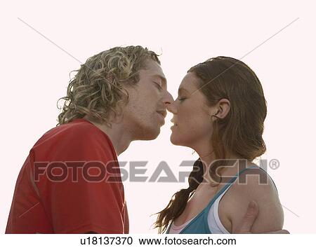 Portrait of a young couple about to kiss. View Large Photo Image Stock Image - Portrait of a young couple about to kiss.. Fotosearch