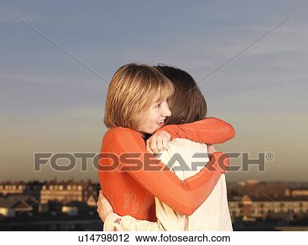 Stock Image - Two women hugging. Fotosearch