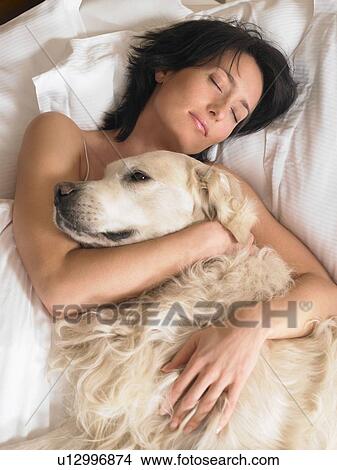 Woman with dog laying View Large Photo Image Picture - Woman with dog laying. Fotosearch