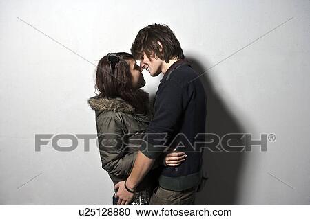 Stock Image - Young couple embracing low view. Fotosearch