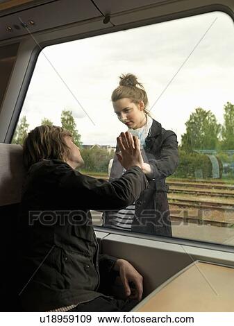 Stock Photo - Young couple on train. Fotosearch