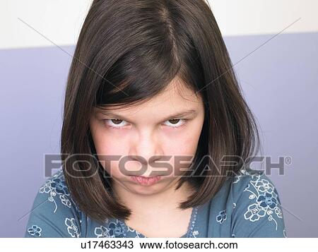 Stock Image - Portrait of a girl, making a face. Fotosearch