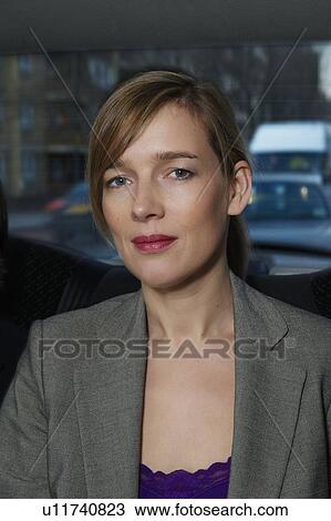 Stock Image - Portrait of woman in taxi . Fotosearch