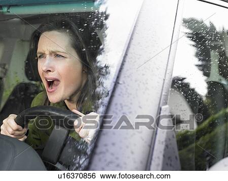 Stock Photograph - Restive woman driving. Fotosearch