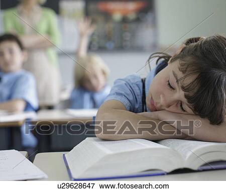 Stock Photo - School girl sleeping at desk. Fotosearch