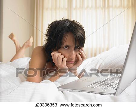 Woman in bed with computer View Large Photo Image Stock Image - Woman in bed with computer. Fotosearch