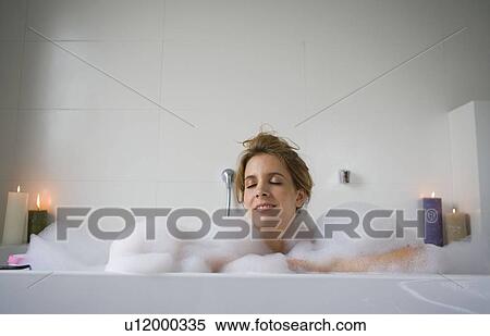 Stock Photography - Woman relaxing in bathtub. Fotosearch
