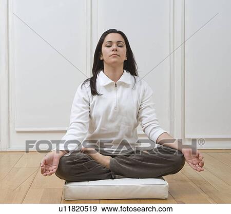 Stock Photo - Woman sitting in lotus position. Fotosearch