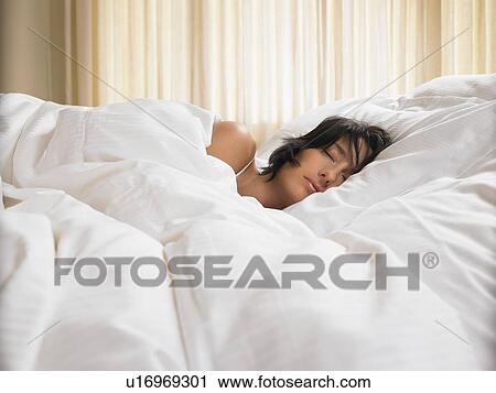 Woman sleeping in bed View Large Photo Image Stock Image - Woman sleeping in bed. Fotosearch