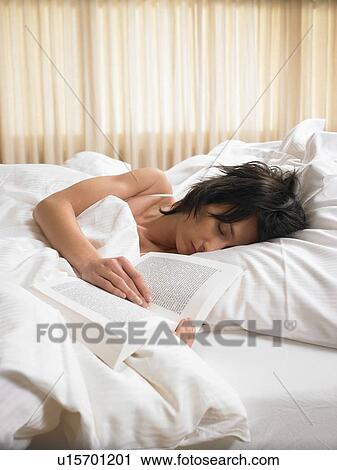 Woman sleeping with an open book View Large Photo Image Stock Image - Woman sleeping with an open book. Fotosearch