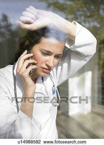 Young female doctor on the phone View Large Photo Image Stock Image - Young female doctor on the phone. Fotosearch