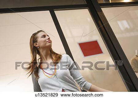 Young woman walking out of shop sale View Large Photo Image Stock Photo - Young woman walking out of shop sale. Fotosearch