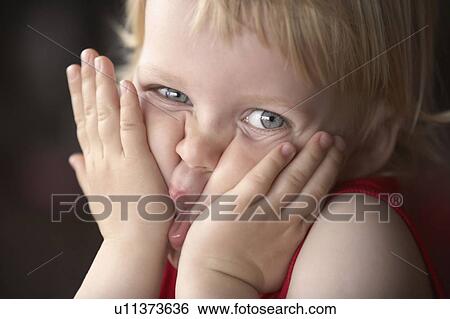 Boy squeezing face, looking at camera View Large Photo Image Stock Photograph - Boy squeezing face, looking at camera. Fotosearch