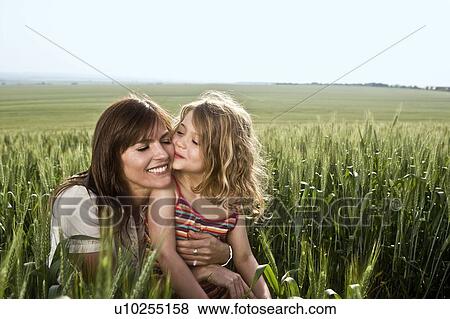 Child kissing mother in wheat-field View Large Photo Image Stock Photo - Child kissing mother in wheat-field. Fotosearch