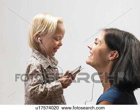 Daughter and mother listening to music View Large Photo Image Stock Image - Daughter and mother listening to music. Fotosearch