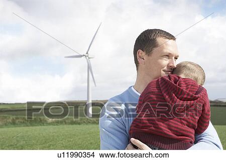 Father holding son on a wind farm View Large Photo Image Picture - Father holding son on a wind farm. Fotosearch