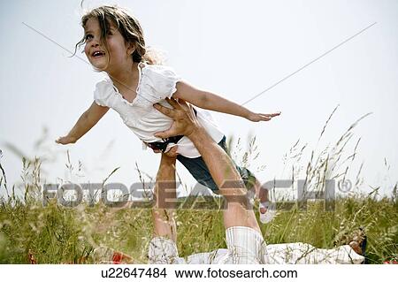 Girl held aloft flying View Large Photo Image Picture - Girl held aloft flying. Fotosearch
