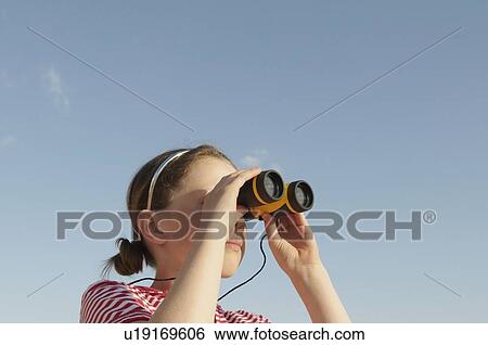 Stock Photograph - Girl looking through binoculars. Fotosearch
