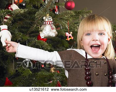 Girl playing with christmas decoration View Large Photo Image Stock Image - Girl playing with christmas decoration. Fotosearch