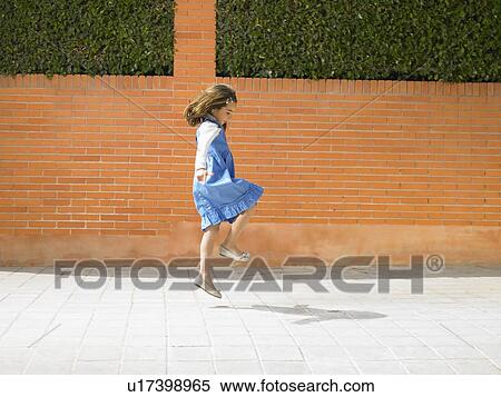 Little girl (5-7) skipping down pavement, Alicante, Spain, View Large Photo Image Stock Photography - Little girl (5-7) skipping down pavement, Alicante, Spain,. Fotosearch