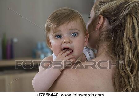 Mother holds baby over shoulder View Large Photo Image Stock Image - Mother holds baby over shoulder. Fotosearch