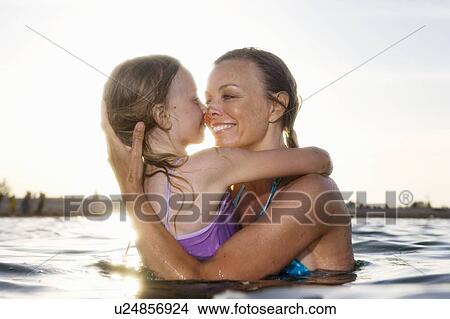 Mother kissing daughter View Large Photo Image Picture - Mother kissing daughter. Fotosearch