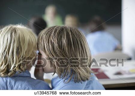 Stock Photo - School boy whispering. Fotosearch