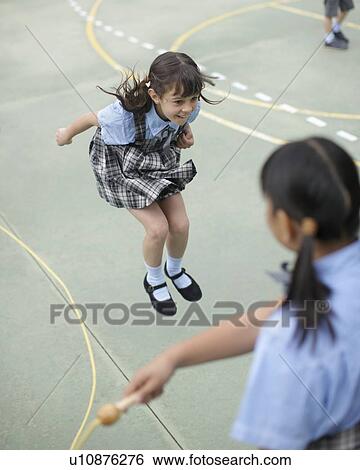 Stock Photograph - School girl skipping rope. Fotosearch