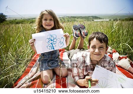 Two children showing their drawings View Large Photo Image Stock Image - Two children showing their drawings. Fotosearch