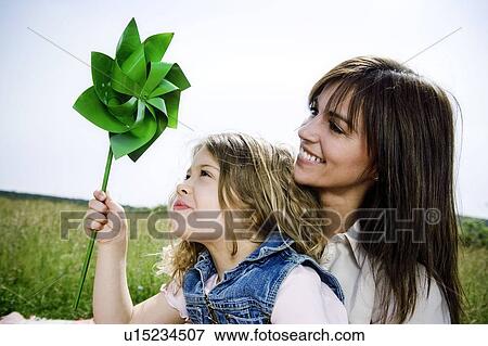 Woman and girl with toy windmill View Large Photo Image Stock Photo - Woman and girl with toy windmill. Fotosearch