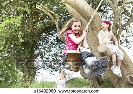 Young girl on rope swing View Large Photo Image Stock Image - Young girl on rope swing. Fotosearch