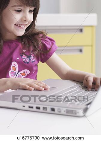 Young girl using laptop View Large Photo Image Stock Image - Young girl using laptop. Fotosearch