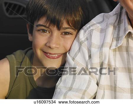 Boy (8-10) leaning against grandfather, smiling, close-up, portrait View Large Photo Image Picture - Boy (8-10) leaning against grandfather, smiling, close-up, portrait. Fotosearch