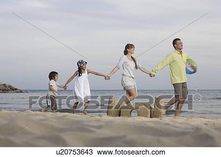 Family holding hands on beach View Large Photo Image Stock Image - Family holding hands on beach. Fotosearch