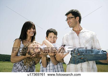 Family holding little girl for portrait View Large Photo Image Stock Image - Family holding little girl for portrait. Fotosearch
