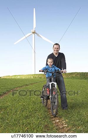 Father and son on a bike View Large Photo Image Stock Image - Father and son on a bike. Fotosearch