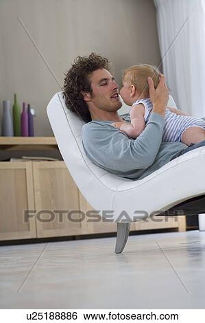 Father looks at baby nose to nose View Large Photo Image Stock Photograph - Father looks at baby nose to nose. Fotosearch