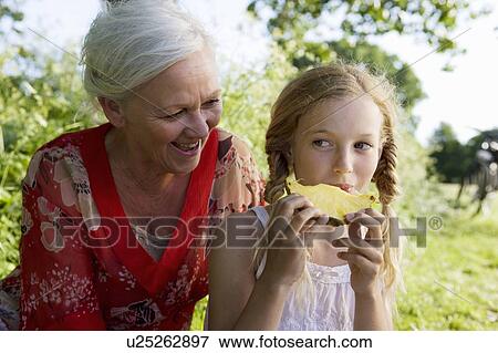Grandmother and granddaughter eating View Large Photo Image Stock Photo - Grandmother and granddaughter eating . Fotosearch
