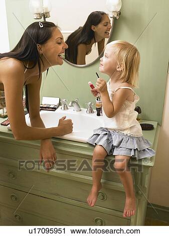 Mother and daughter applying makeup. View Large Photo Image Stock Image - Mother and daughter applying makeup.. Fotosearch