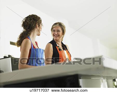 Stock Photo - Mother and daughter in the kitchen. Fotosearch