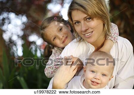 Stock Image - Mother with children outdoors. Fotosearch