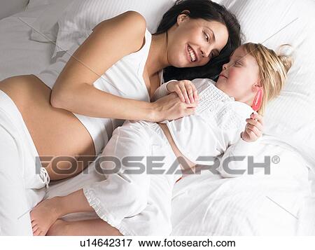 Pregnant mother and daughter laughing View Large Photo Image Stock Photo - Pregnant mother and daughter laughing. Fotosearch