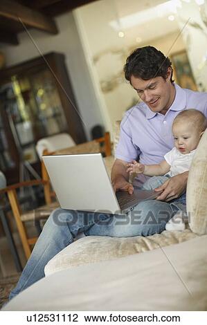 Father sitting at laptop with young son View Large Photo Image Stock Image - Father sitting at laptop with young son. Fotosearch