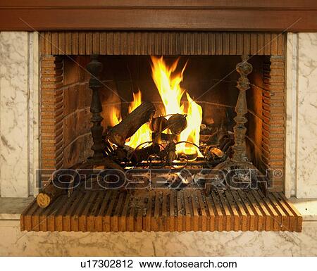 Log fire burning in fireplace with red brick surround View Large Photo Image Stock Image - Log fire burning in fireplace with red brick surround. Fotosearch