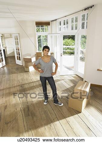 Stock Photography - Woman moving in empty house.. Fotosearch