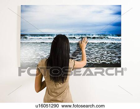 Woman touching photograph of the sea. View Large Photo Image Stock Image - Woman touching photograph of the sea.. Fotosearch