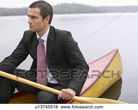 Stock Photo - Businessman in kayak. Fotosearch